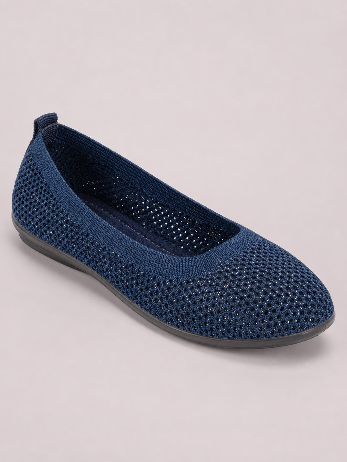 Navy blue mesh flat slip-on shoe with a rounded toe, breathable perforated upper, low heel, and sturdy rubber sole.