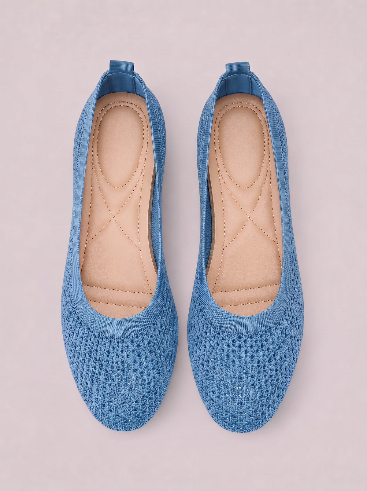 Blue mesh flat slip-on shoes with rounded toes, low heels, cushioned insoles, stitched detailing, and pull tabs.