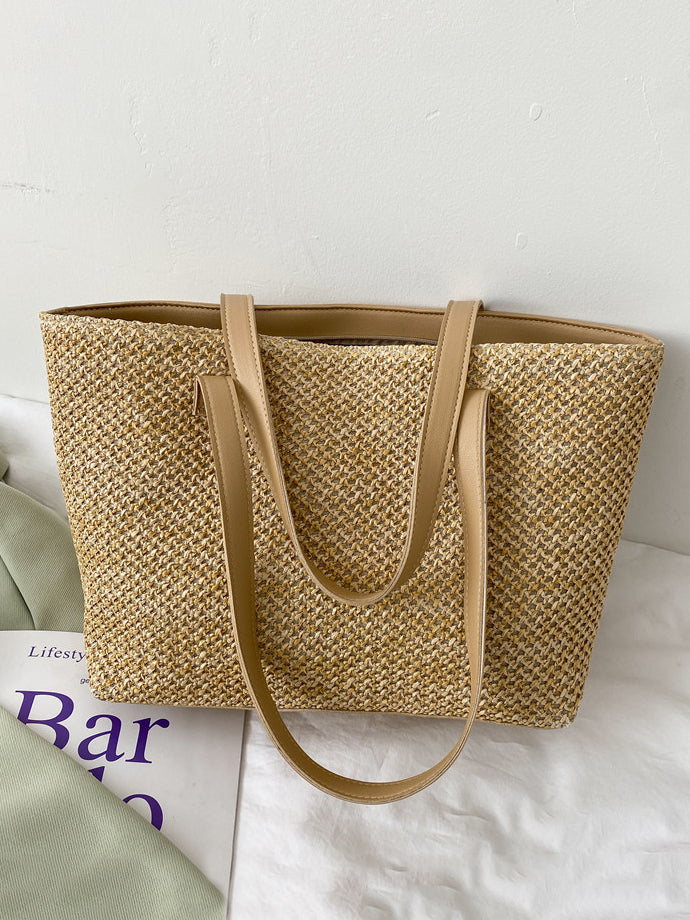 Medium tan woven tote bag with a clean, structured rectangular silhouette, open top, textured construction, and long shoulder straps for hand or over-the-shoulder carry.