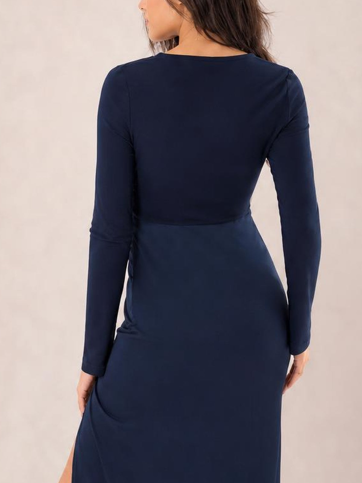 Model shown from behind wearing a navy Split Round Neck Long Sleeve Midi Dress with a fitted silhouette, ruched side detail, and lower side slit.