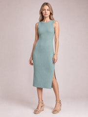 Model wears a sage green ribbed Split Round Neck Sleeveless Dress with a fitted midi silhouette and side split, standing with one leg forward.