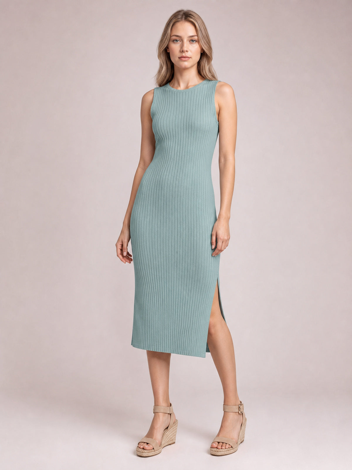 Model wears a sage green ribbed Split Round Neck Sleeveless Dress with a fitted midi silhouette and side split, standing with one leg forward.