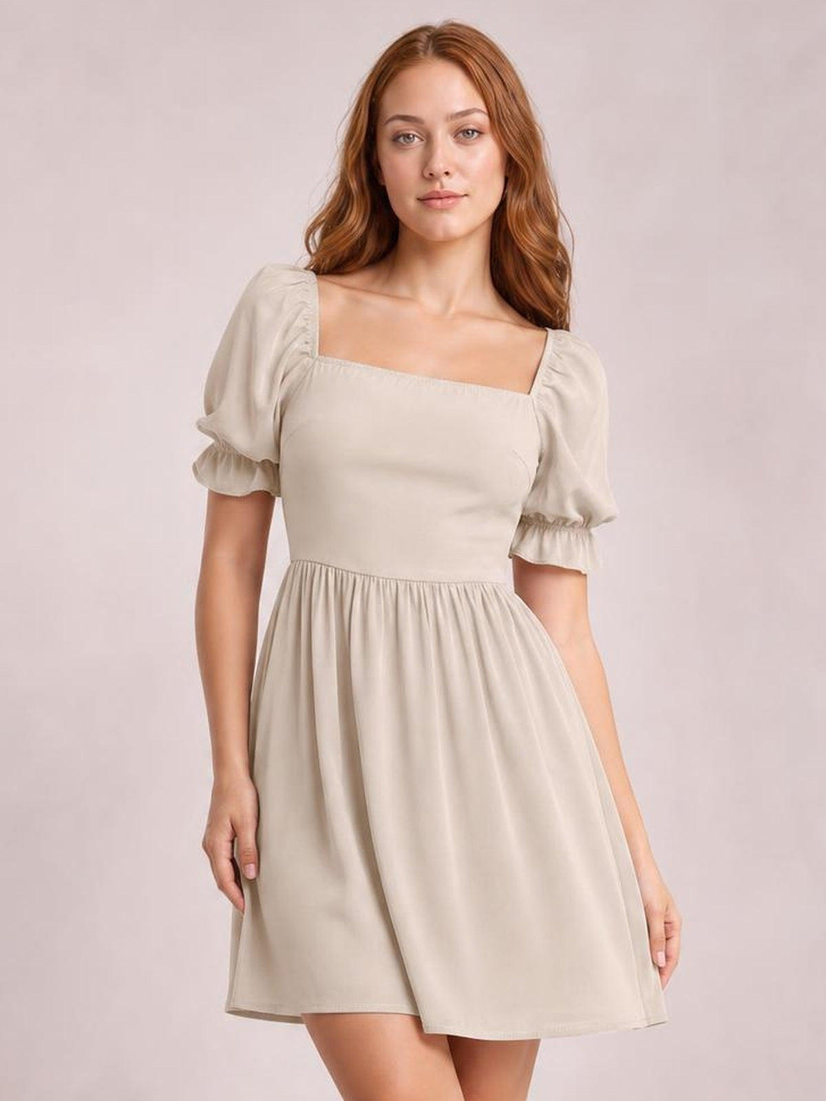 Model facing forward wears a beige square-neck mini dress with flounce sleeves, fitted bodice, gathered waist, and a softly flared skirt.