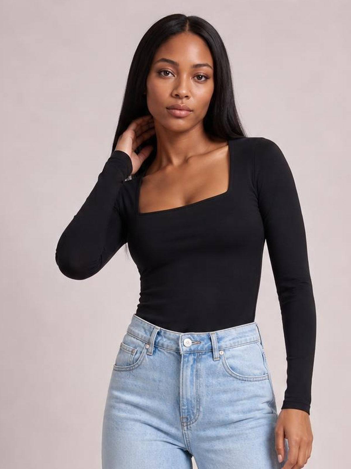Model wearing a black square neck long sleeve T-shirt with a fitted silhouette, opaque stretch fabric, and clean basic construction.