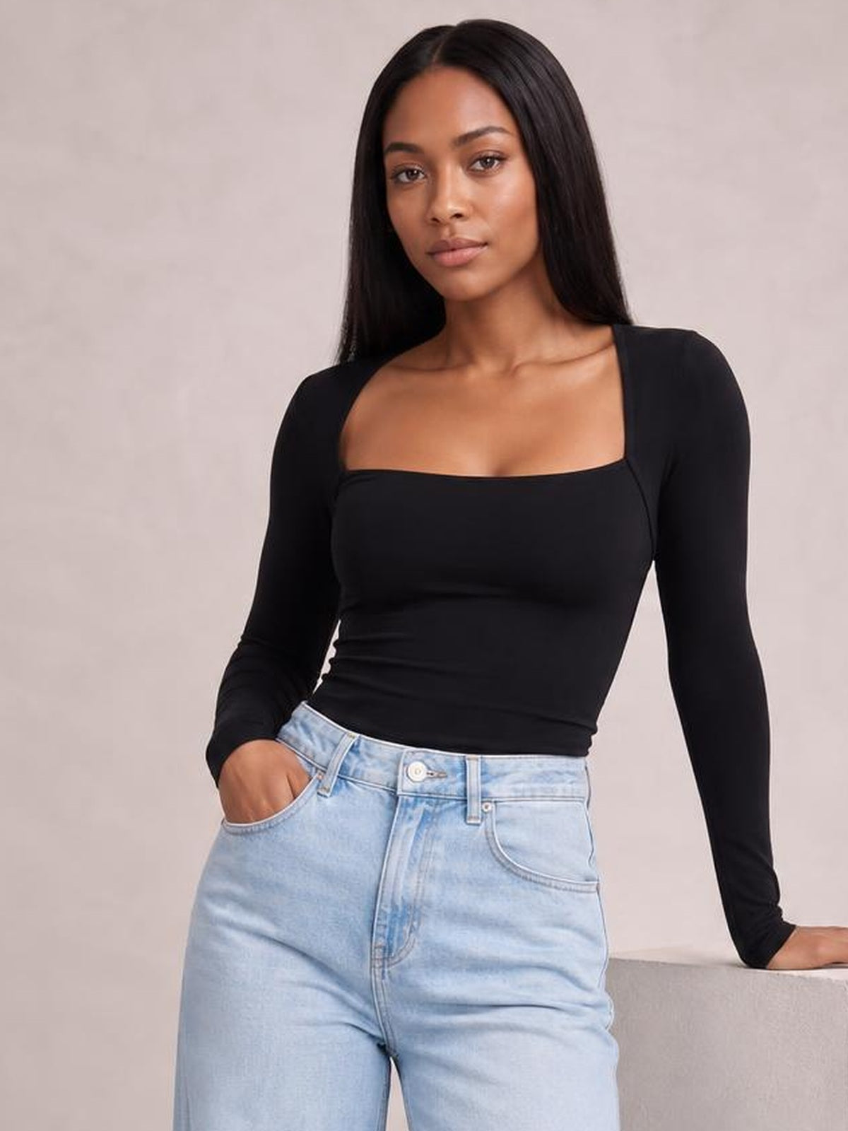 Model wearing a black square neck long sleeve T-shirt with a fitted silhouette, stretch construction, and a clean basic style.