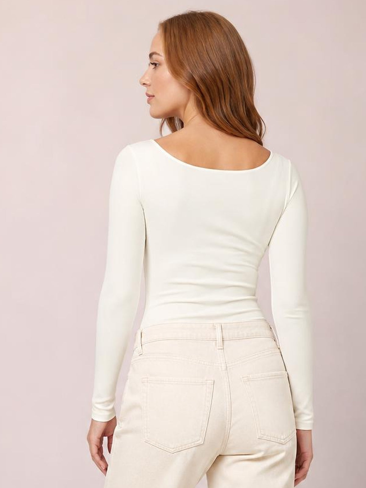 Model turned away to show a fitted white square neck long sleeve T-shirt with a smooth stretch silhouette and clean construction.