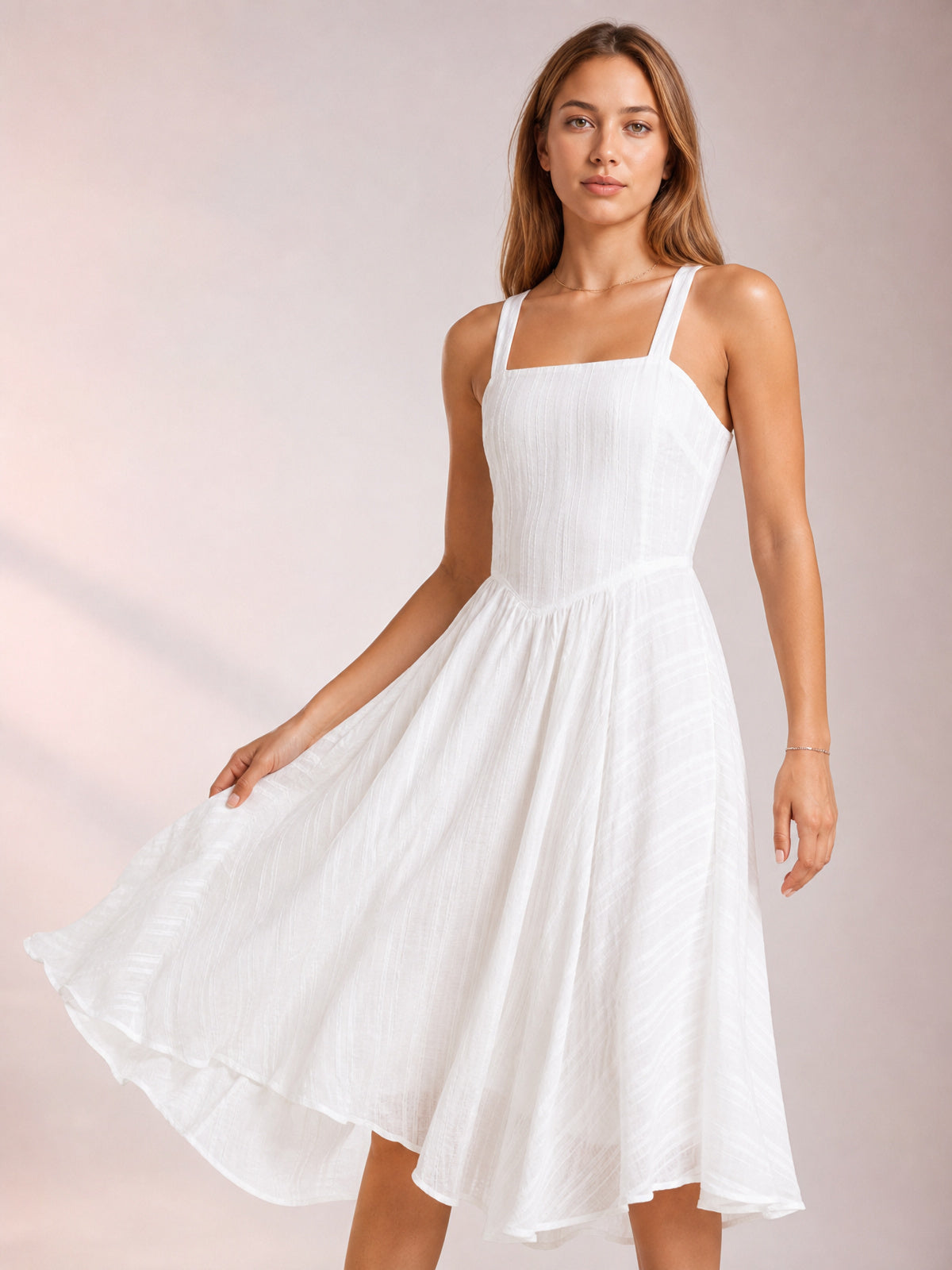 Model poses in a white Square Neck Midi Cami Dress with wide shoulder straps, a fitted bodice, textured fabric, and a full flowing skirt.