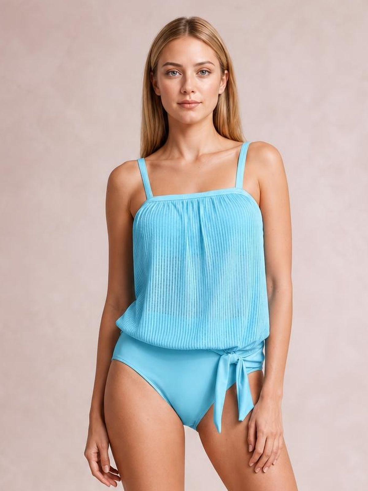 Model wearing a light blue square neck spaghetti strap tankini set with a ribbed loose silhouette, high-cut bottoms, and a tied side detail.