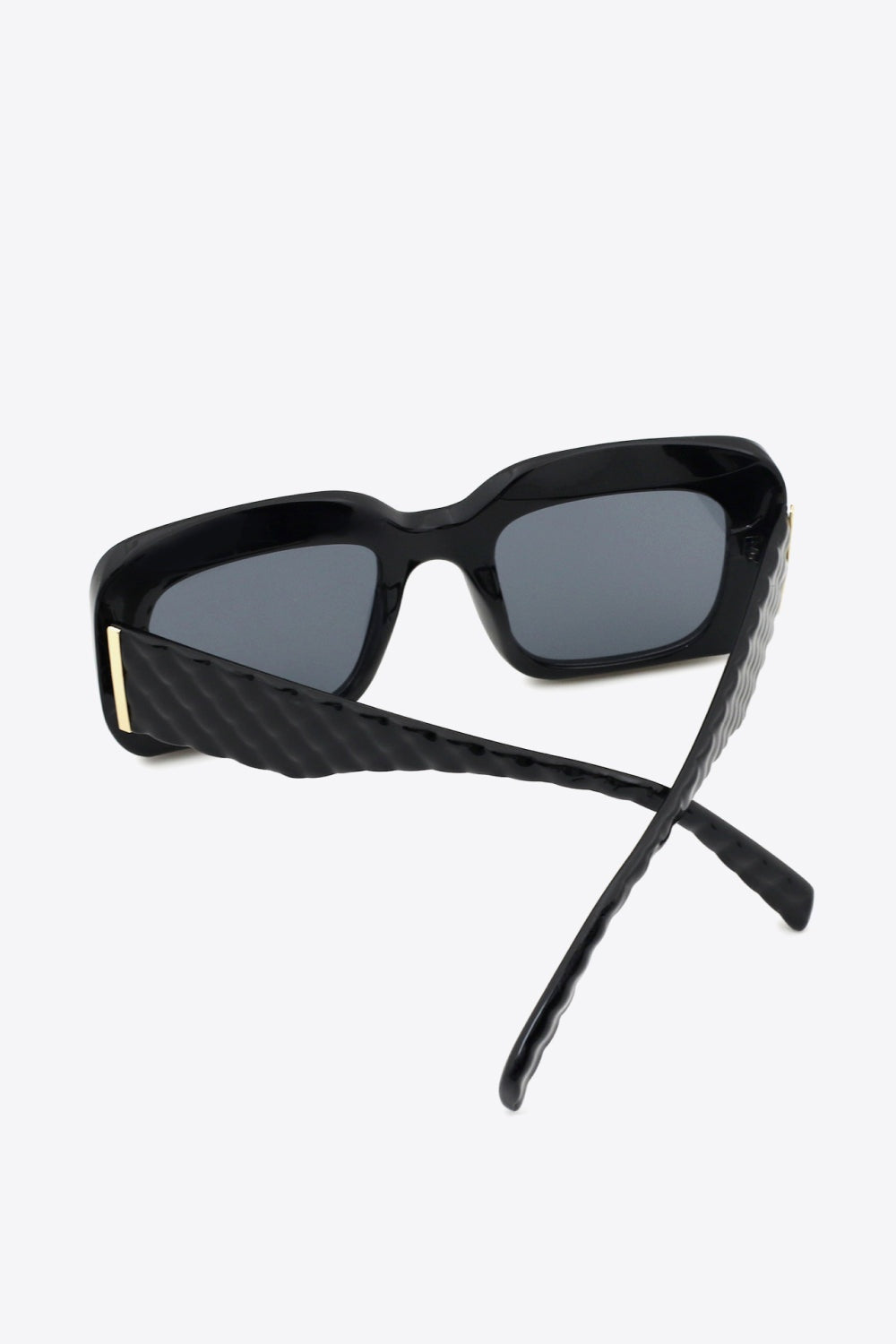 Black square polycarbonate UV400 sunglasses feature dark lenses, a bold structured frame, and thick sculpted temples crossed open to showcase the construction.