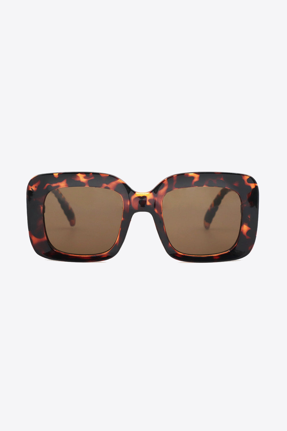 Square polycarbonate sunglasses feature a bold tortoiseshell frame, warm brown lenses, and a structured oversized silhouette with rounded-square construction.