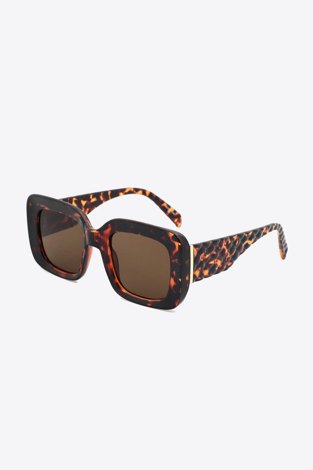 Square polycarbonate sunglasses feature oversized tortoiseshell frames, brown lenses, and thick patterned temples for a bold, structured silhouette.