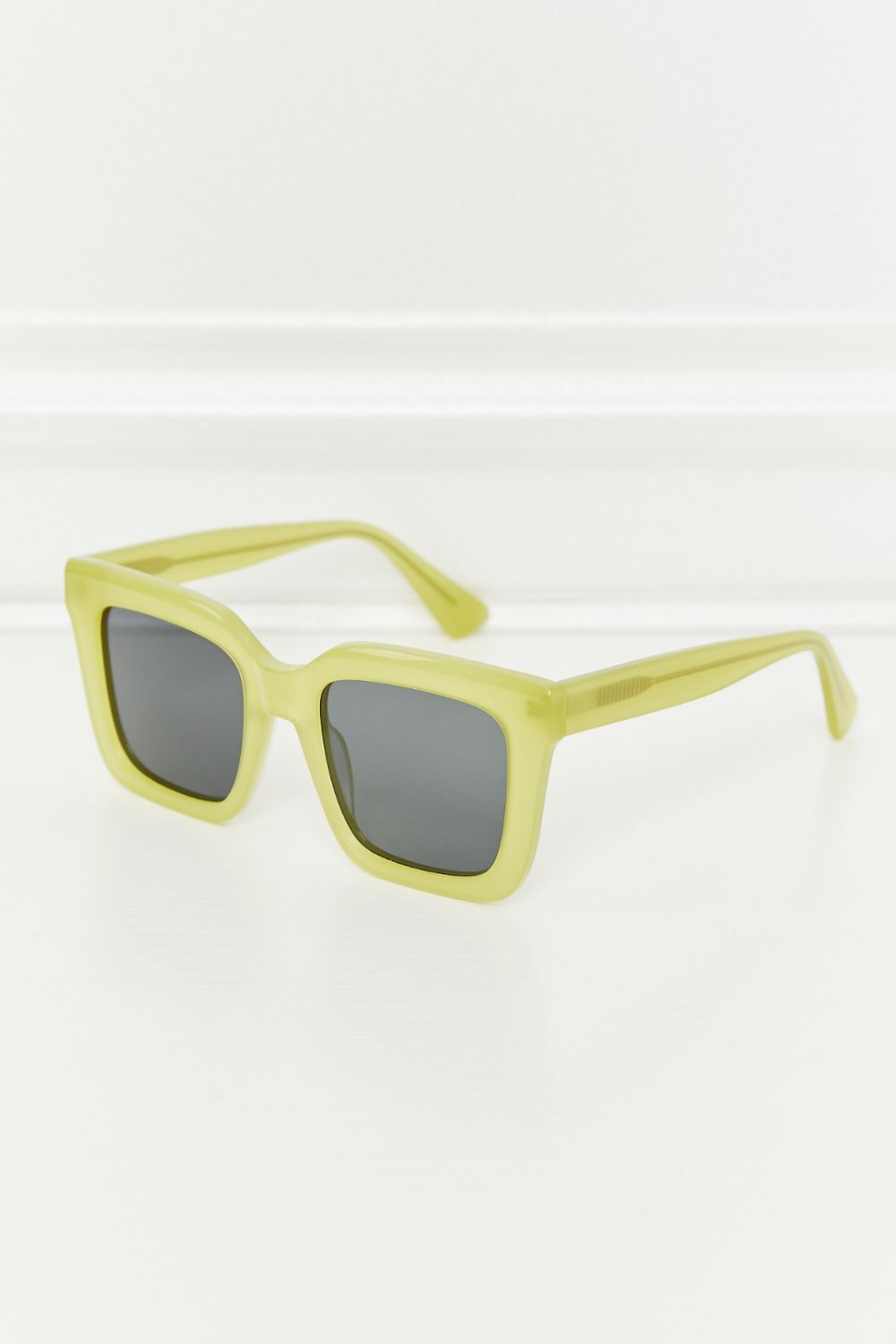 Square TAC polarized sunglasses with a vivid neon yellow acetate frame, dark lenses, bold structured silhouette, and open temples.