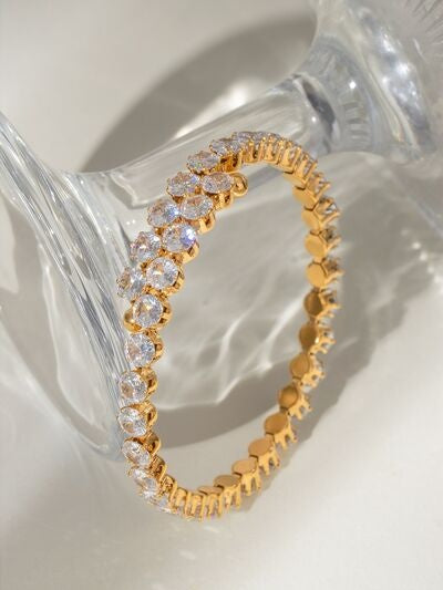 Gold-tone stainless steel inlaid zircon bracelet featuring a flexible circular silhouette and a sparkling row of round clear stones along the linked band.