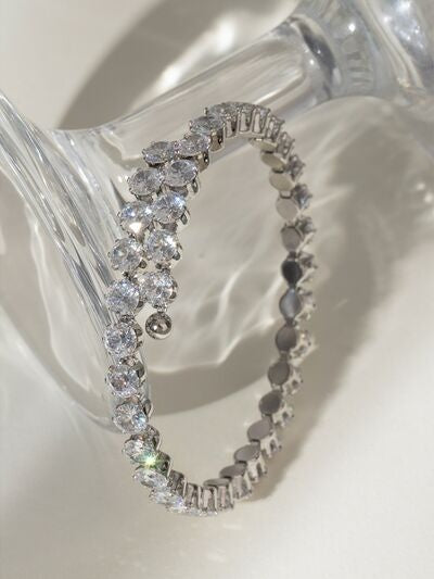 Stainless steel inlaid zircon bracelet with a polished linked construction and sparkling round stones arranged around a slim oval silhouette.