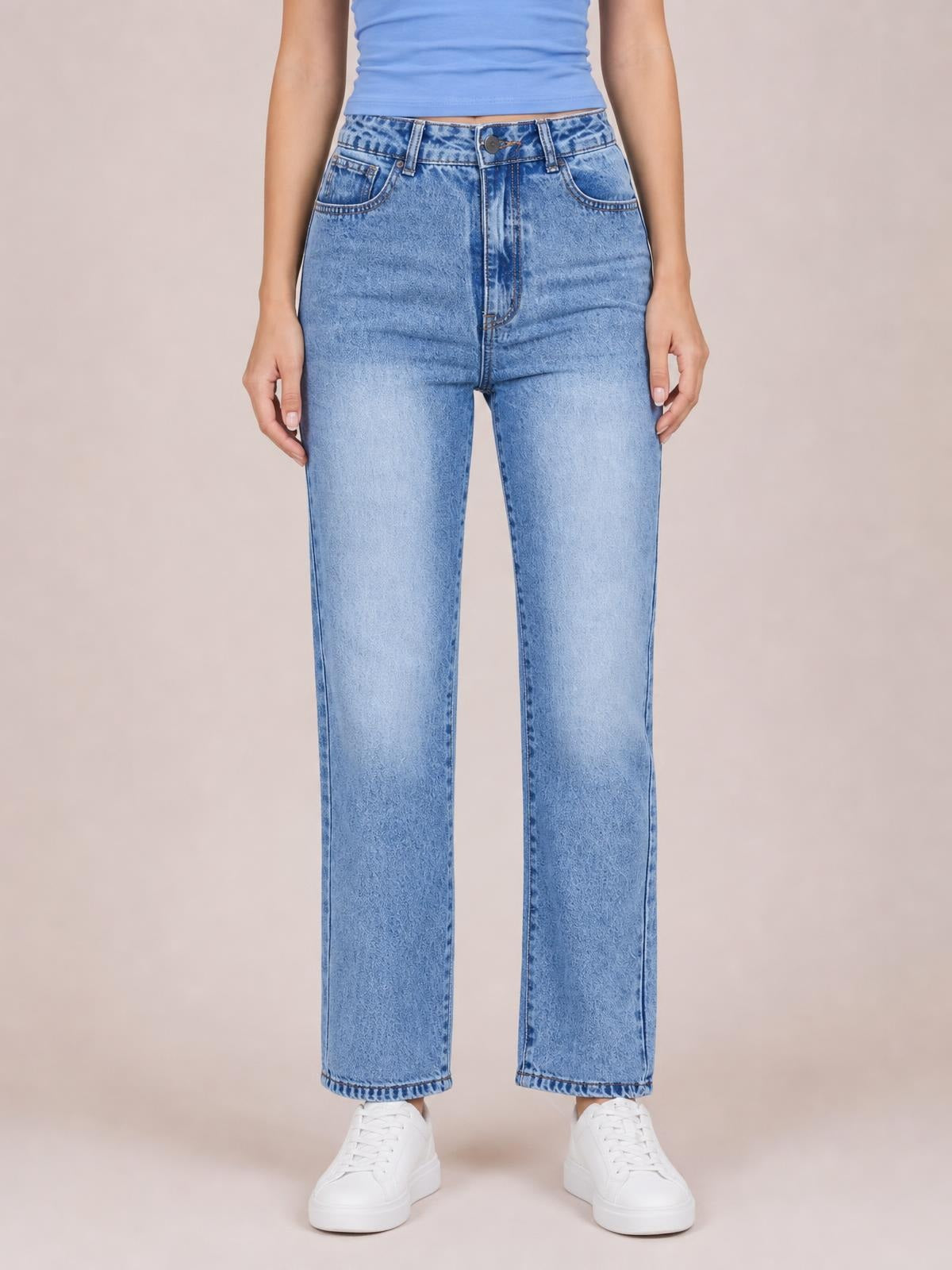 Model standing in light blue straight-leg jeans with front pockets, a button closure, belt loops, contrast stitching, and a relaxed silhouette.