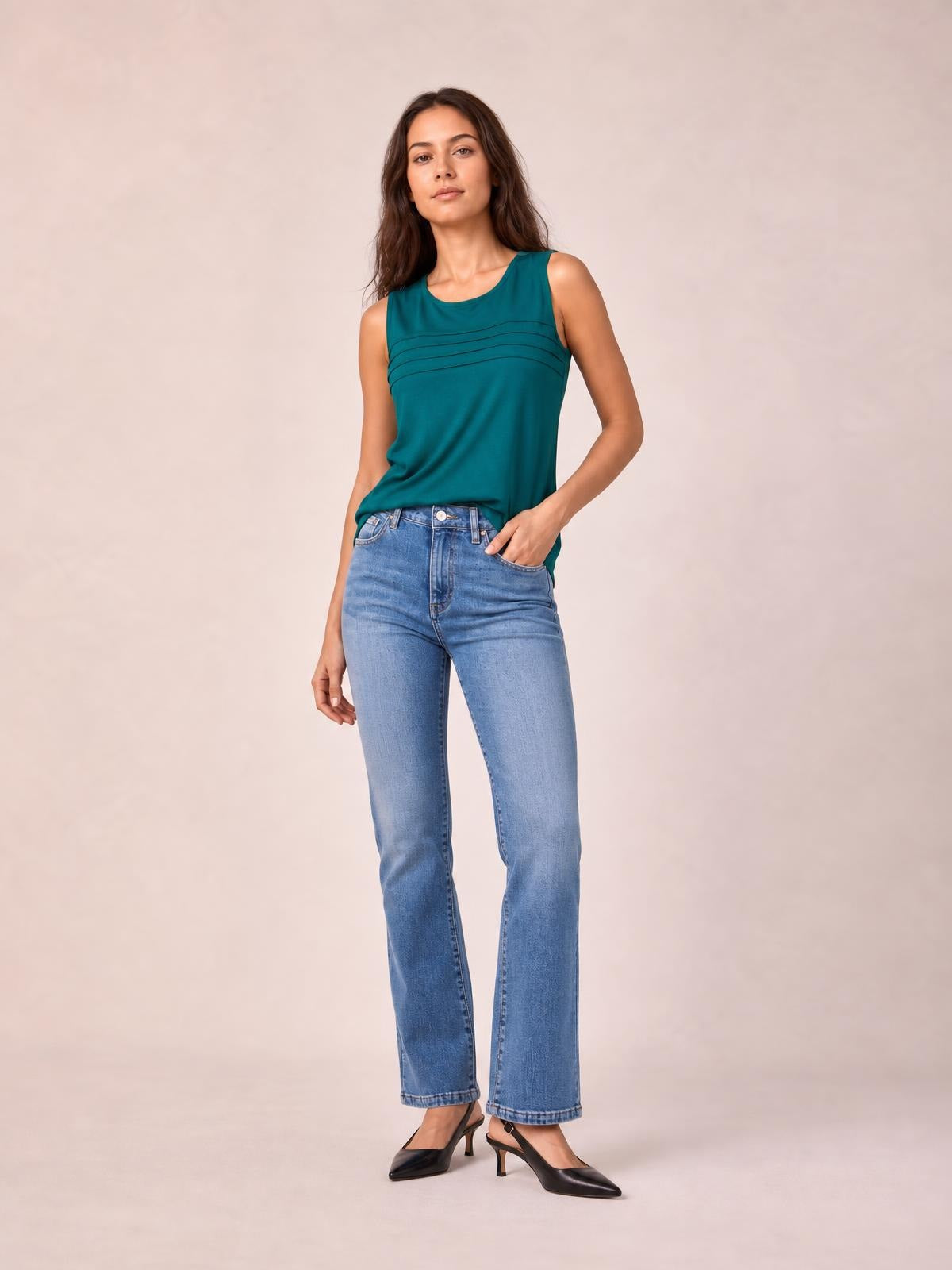 Model wearing light-wash straight leg jeans with visible pockets, a button fly, belt loops, and a relaxed full-length silhouette.