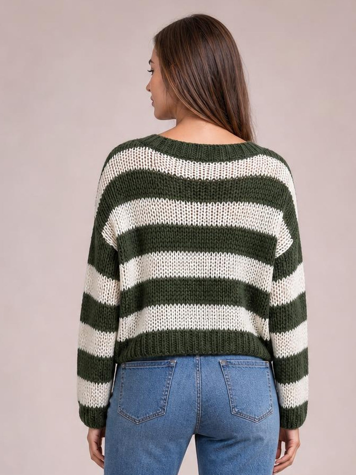 Model shown from the back wearing a dark green and ivory striped boat neck long sleeve sweater with a relaxed silhouette and ribbed trim.