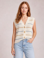 Model wears a cream striped button-down sweater vest with a V-neck, sleeveless cut, relaxed silhouette, and three visible front buttons, posing with one hand in her jeans pocket.