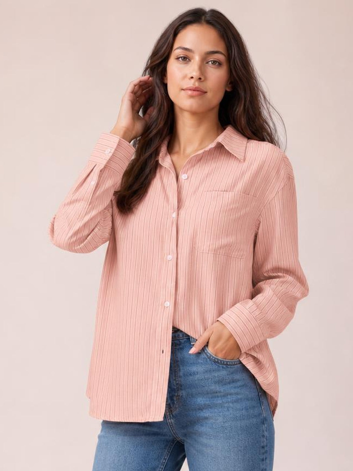 Model wears a blush pink striped button-up long-sleeve shirt with a collared neckline, front buttons, chest pocket, and relaxed straight silhouette.