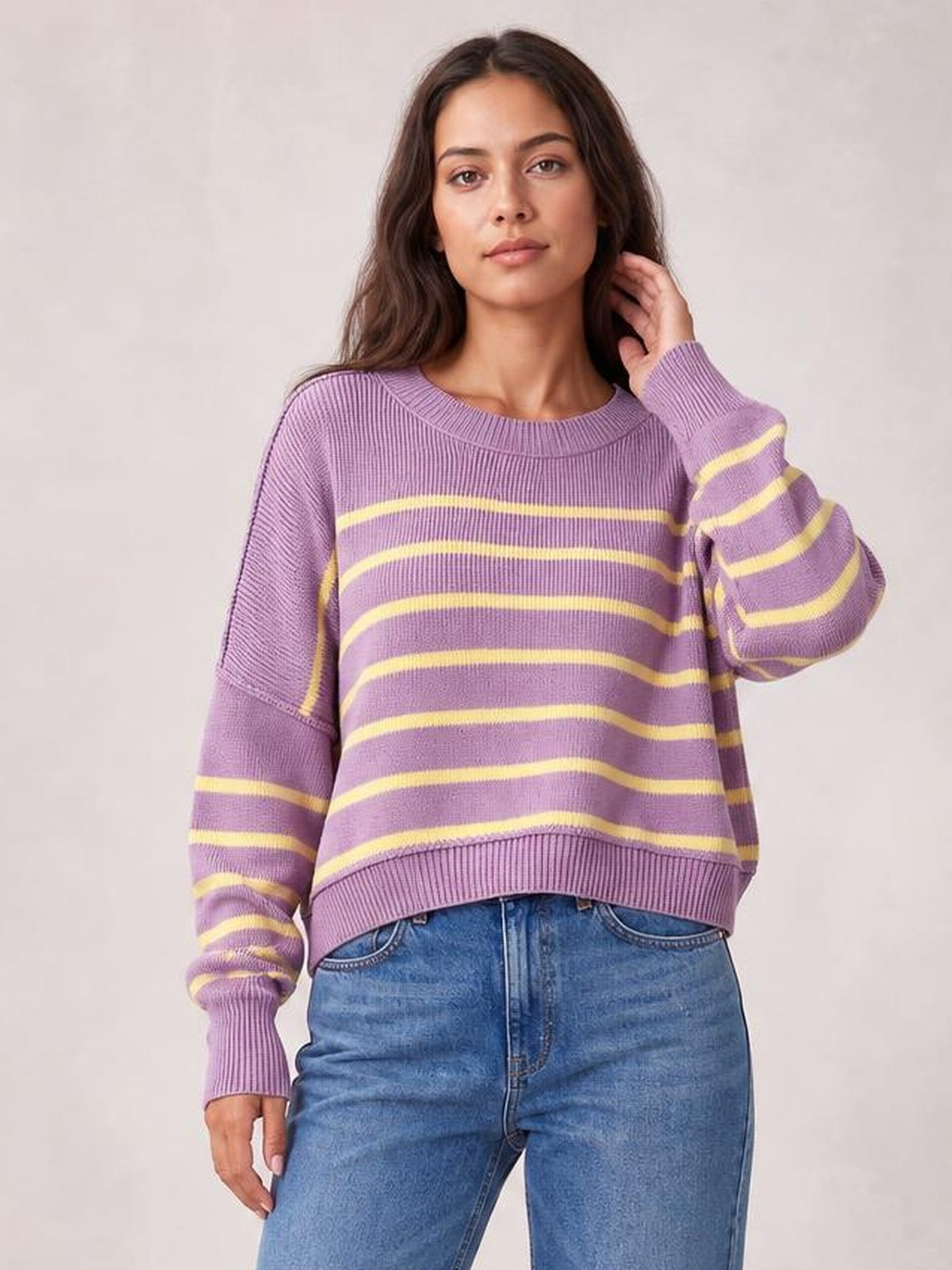 Model wears a lavender striped dropped-shoulder round-neck pullover sweater with long lantern sleeves, ribbed cuffs and hem, and a relaxed silhouette.