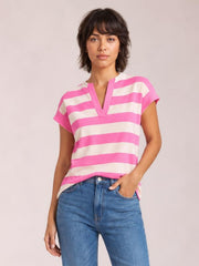 A model stands in a relaxed pose wearing a pink-and-white striped blouse with a notched V-neckline, cap sleeves, and a loose straight silhouette.