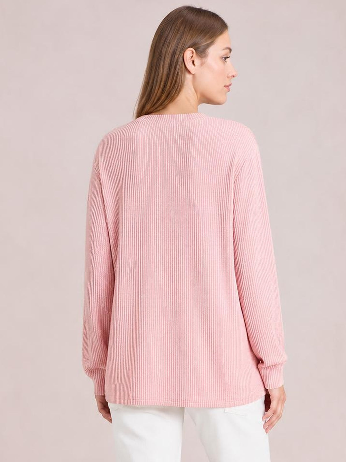 A model shown from the back wears a pink striped long sleeve T-shirt with a relaxed straight silhouette, ribbed cuffs, and a softly rounded hem.