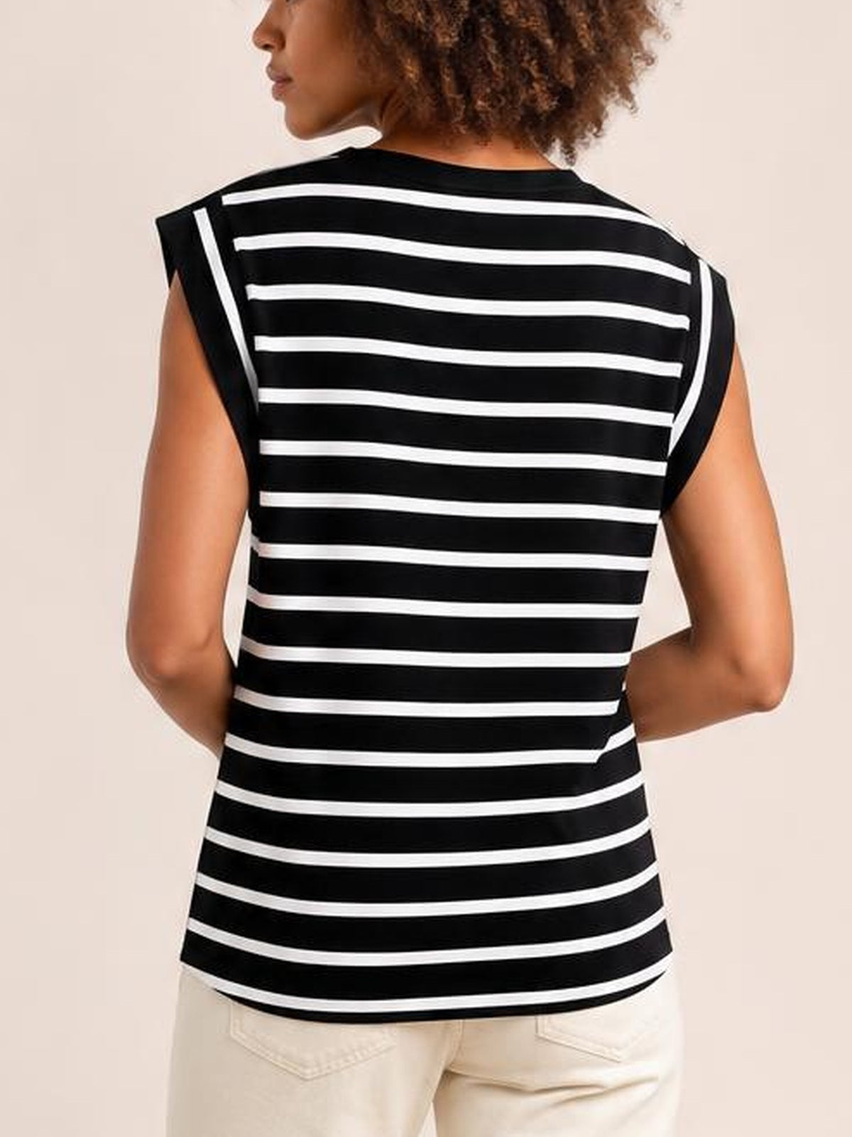 Model shown from the back wears a black-and-white striped round-neck cap-sleeve T-shirt with a relaxed, slightly fitted silhouette and straight hem.
