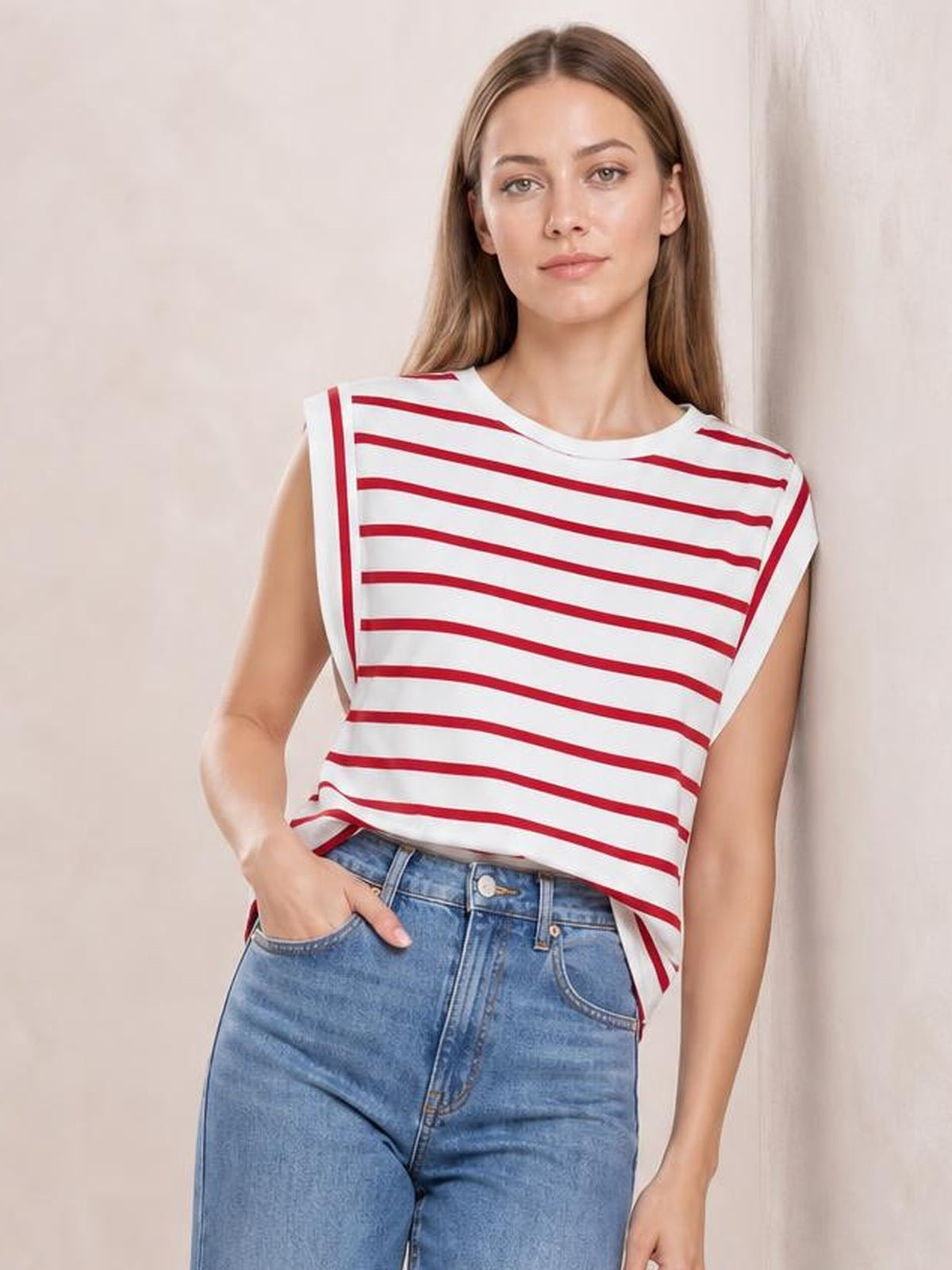 Model poses in a white striped round neck cap sleeve T-shirt with red horizontal stripes, a relaxed silhouette, and a slightly tucked hem.