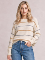 Model wearing a cream striped round-neck drop-shoulder sweater with a relaxed silhouette, long sleeves, and ribbed cuffs and hem.