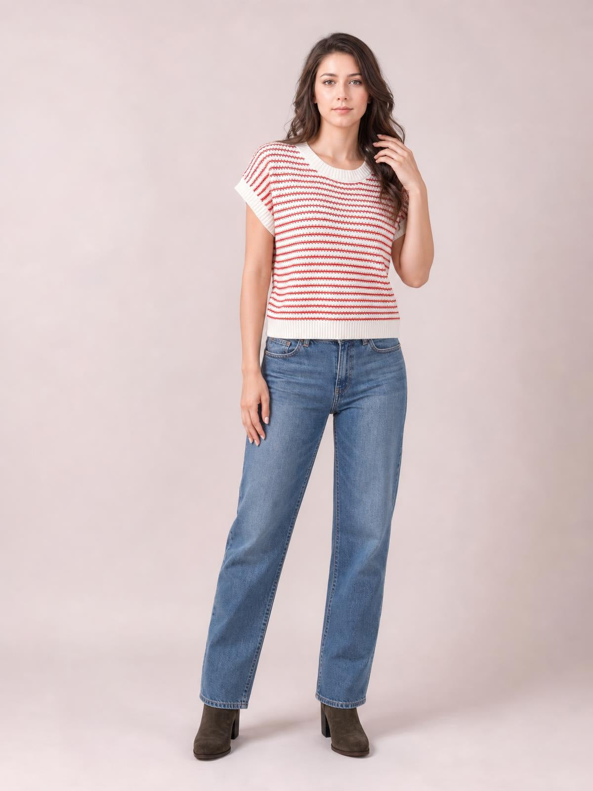 Model wears a white striped round neck short sleeve knit top with red horizontal stripes, ribbed trim, and a fitted silhouette, touching her hair.