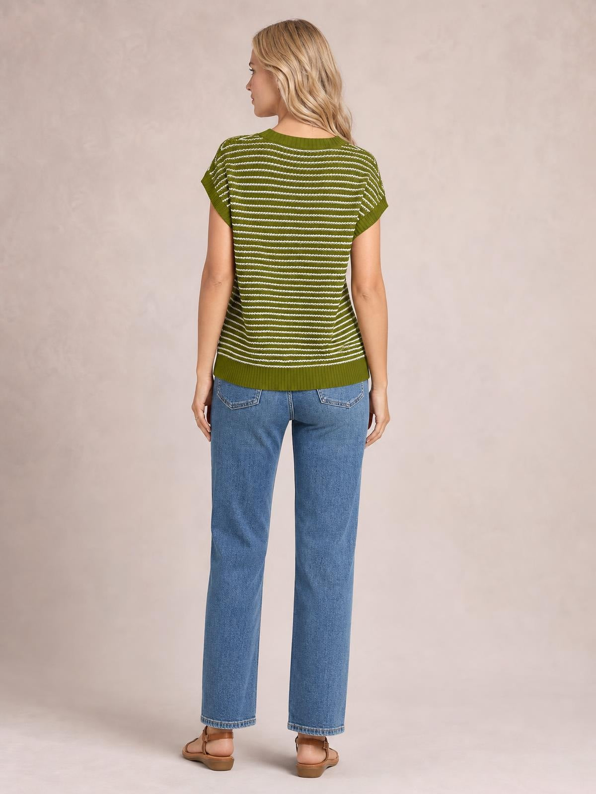 Back view of a model wearing an olive green striped round neck short sleeve knit top with white horizontal stripes, ribbed trim, and a relaxed silhouette.