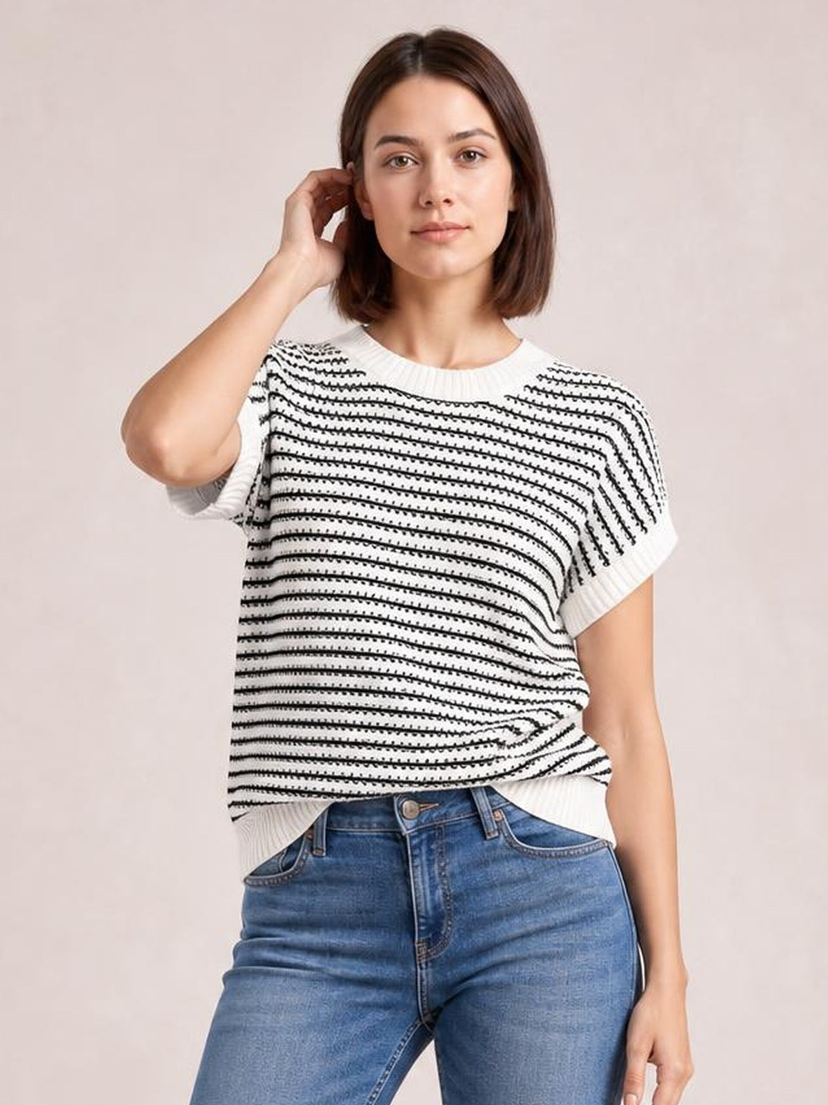 Model wearing a black-and-white striped round neck short sleeve knit top with a relaxed silhouette and ribbed neckline, cuffs, and hem.