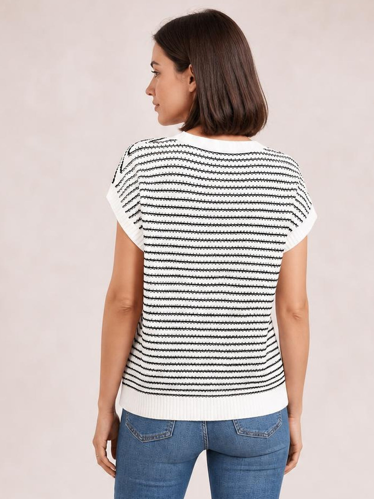 Model shown from the back wears a white striped round-neck short-sleeve knit top with a relaxed silhouette, textured horizontal lines, and ribbed hem.