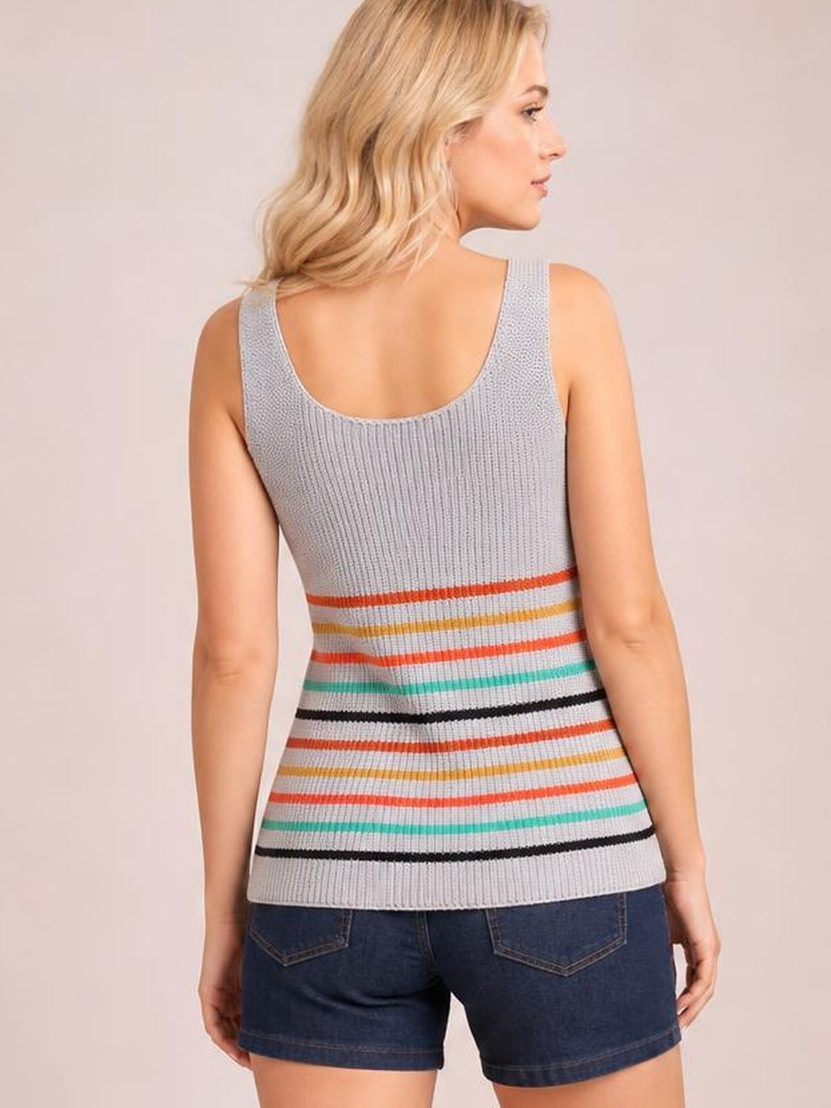 A model wears a light gray striped knit tank with colorful horizontal bands, wide straps, ribbed construction, and a fitted silhouette, viewed from the back.