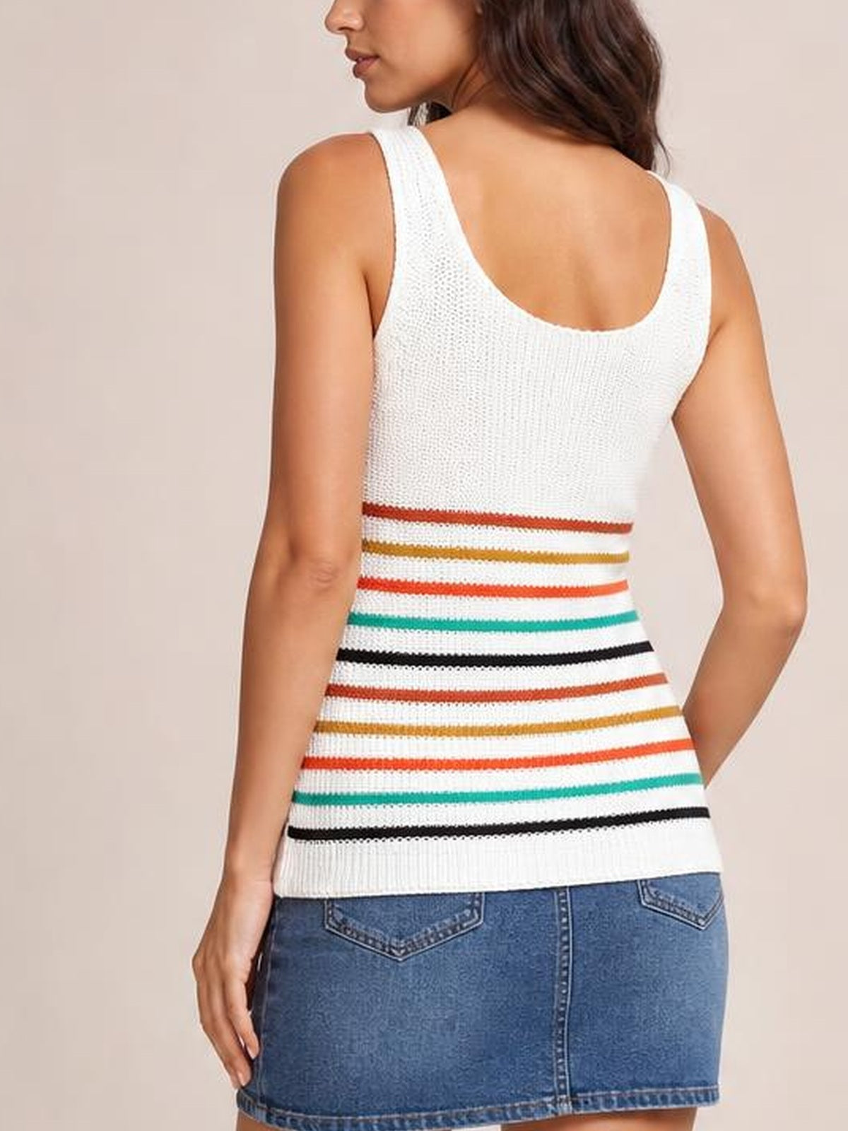 Model turned away wears a white striped knit tank with wide shoulder straps, scoop back, colorful horizontal bands, and a fitted silhouette.