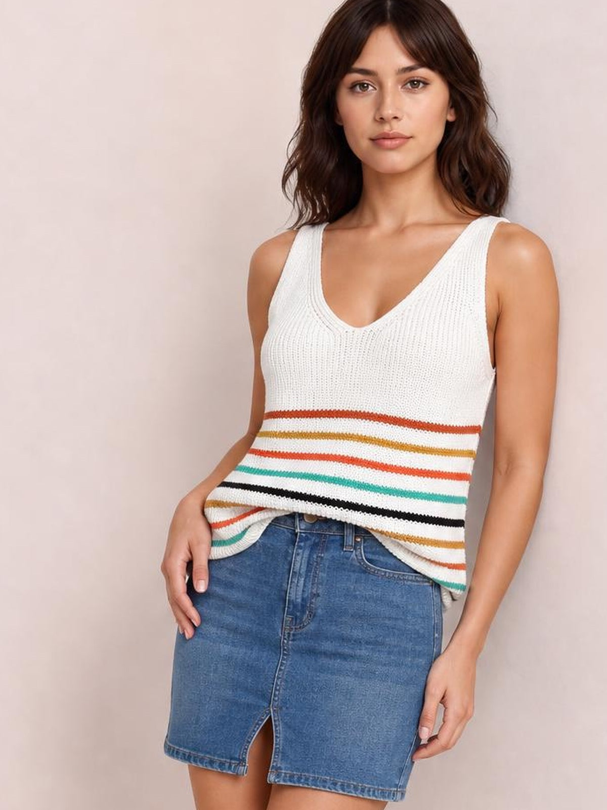 Model wears a white striped V-neck knit tank with multicolor horizontal bands, sleeveless construction, textured knit, and a relaxed straight silhouette.