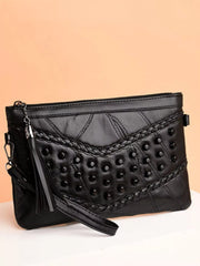 Black medium PU leather crossbody bag with studded quilted panels, braided trim, a top zipper, and an adjustable strap.