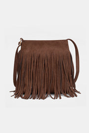 Brown suede fringe shoulder bag with a softly structured rectangular silhouette, long fluid fringe, slender strap, and silver-tone ring hardware.