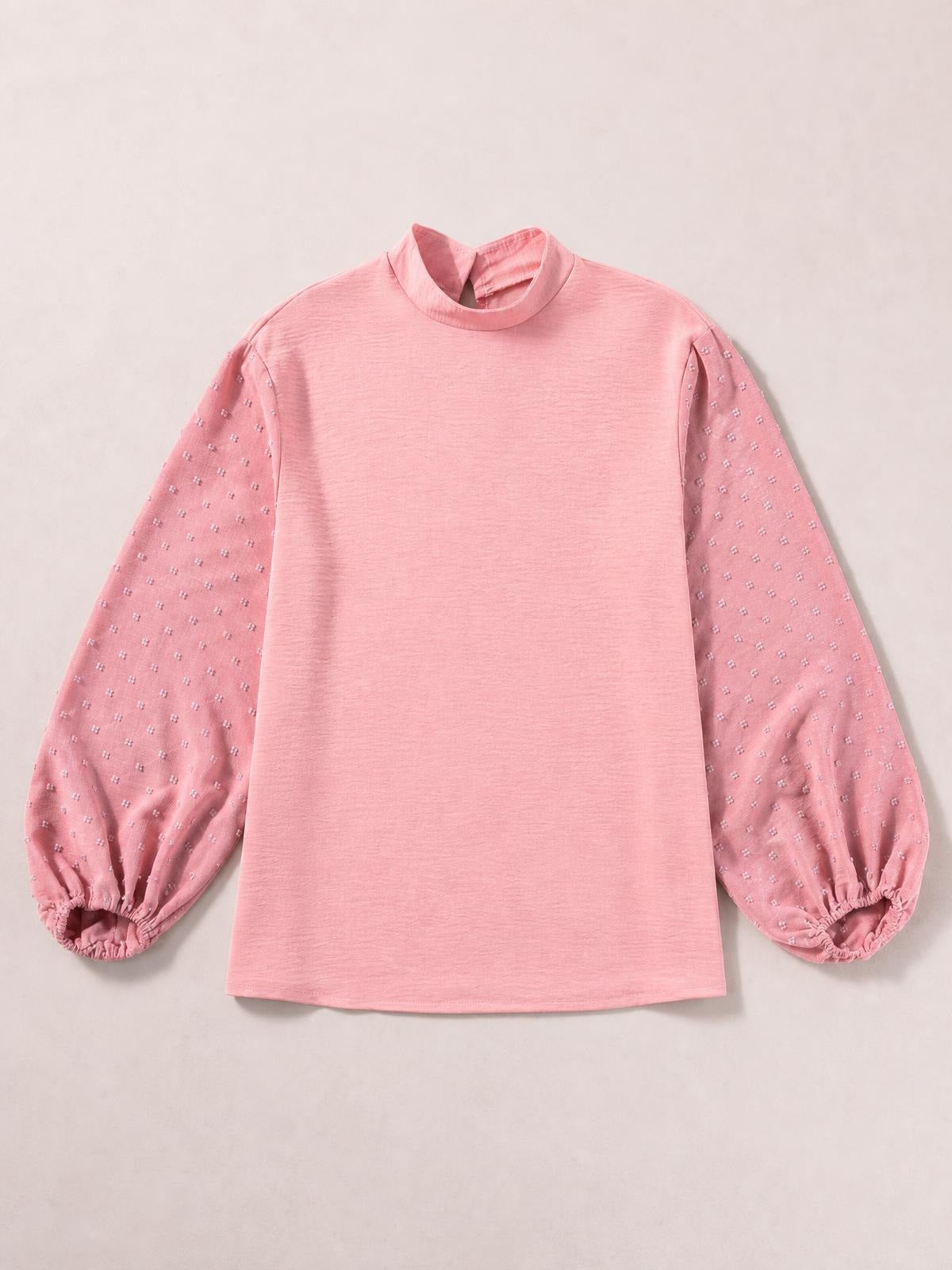 Pink Swiss dot mock neck blouse with voluminous balloon sleeves, gathered elastic cuffs, and a straight, relaxed silhouette.