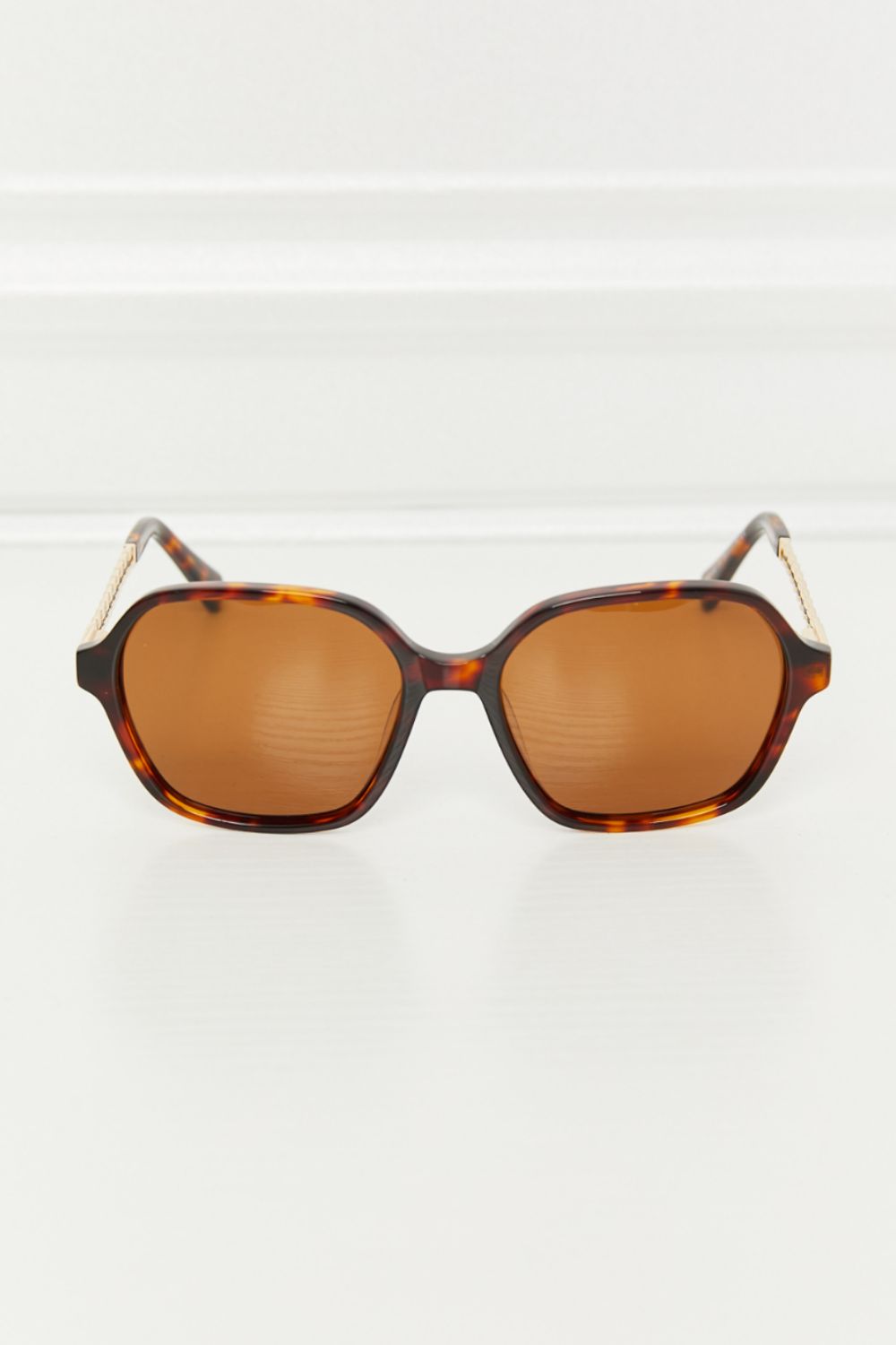 Brown full-rim TAC polarized sunglasses feature a softly rounded square silhouette, warm-toned lenses, tortoiseshell acetate frames, and metal-accented temples.