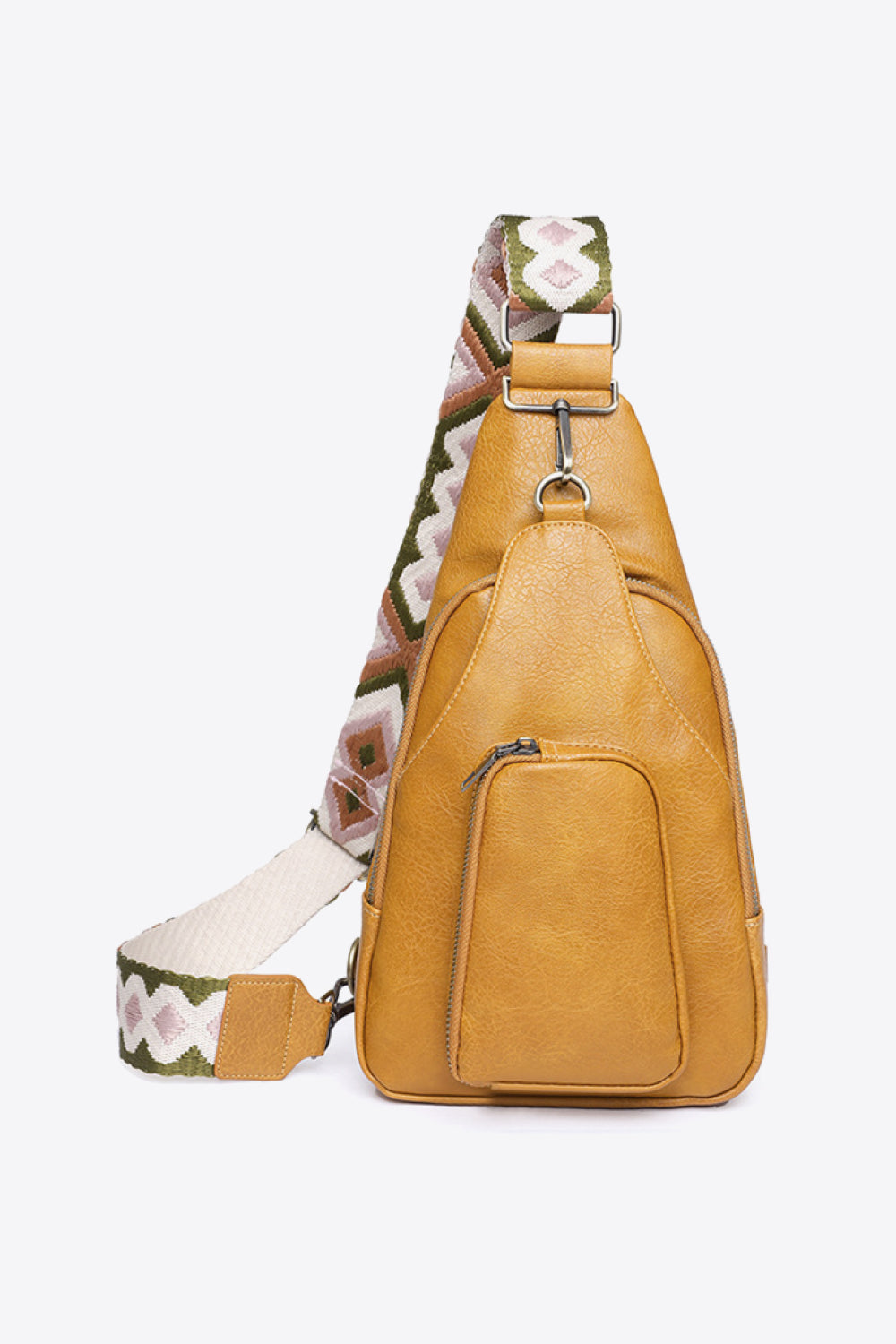 Mustard PU leather sling bag with a compact tapered silhouette, front zip pocket, silver-tone hardware, and a broad patterned shoulder strap.