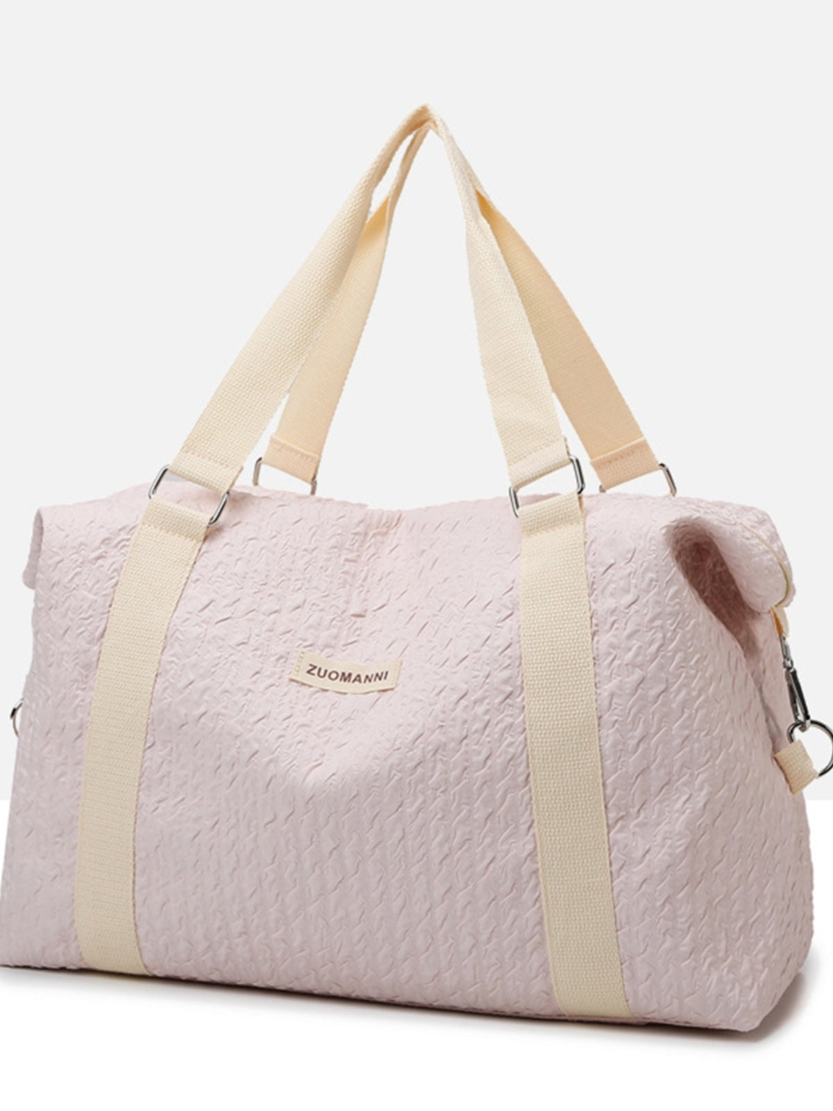 Large pale pink textured Oxford cloth travel bag with a softly structured silhouette, wide webbed handles, detachable shoulder strap, and metal hardware.