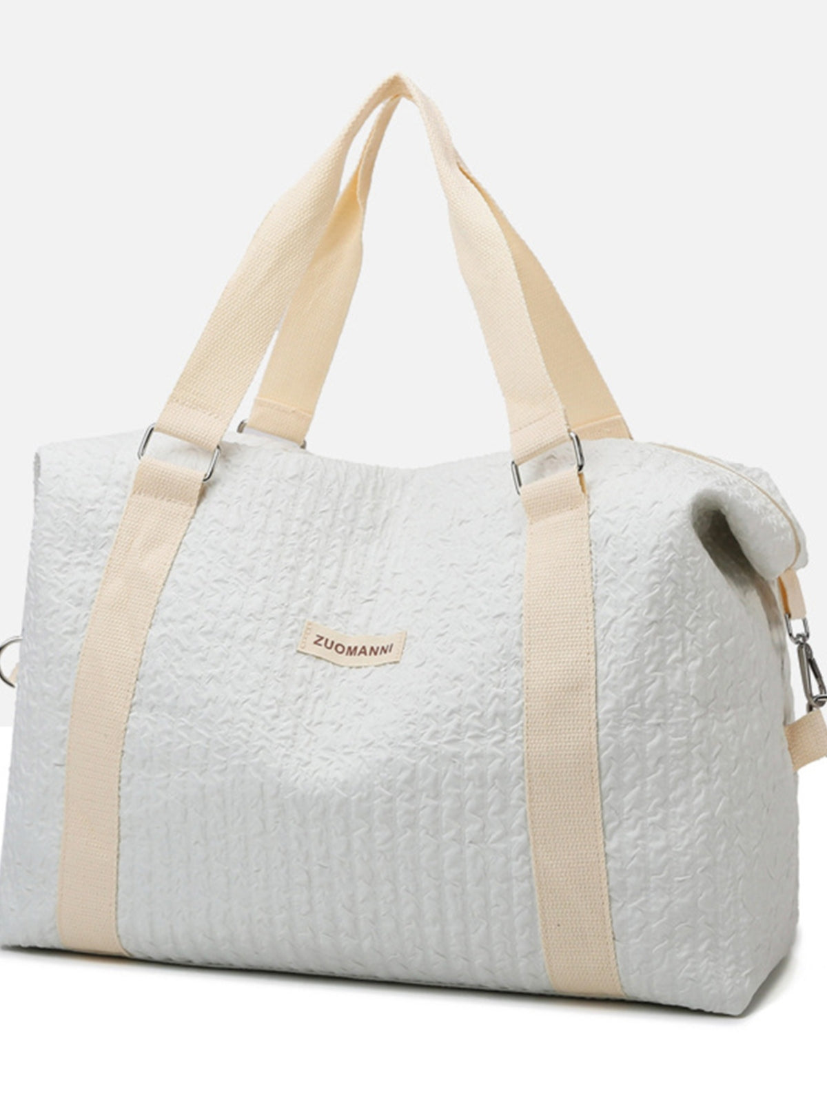 Large white textured Oxford cloth travel bag with a softly structured silhouette, wide beige top handles, and a detachable shoulder strap with metal hardware.