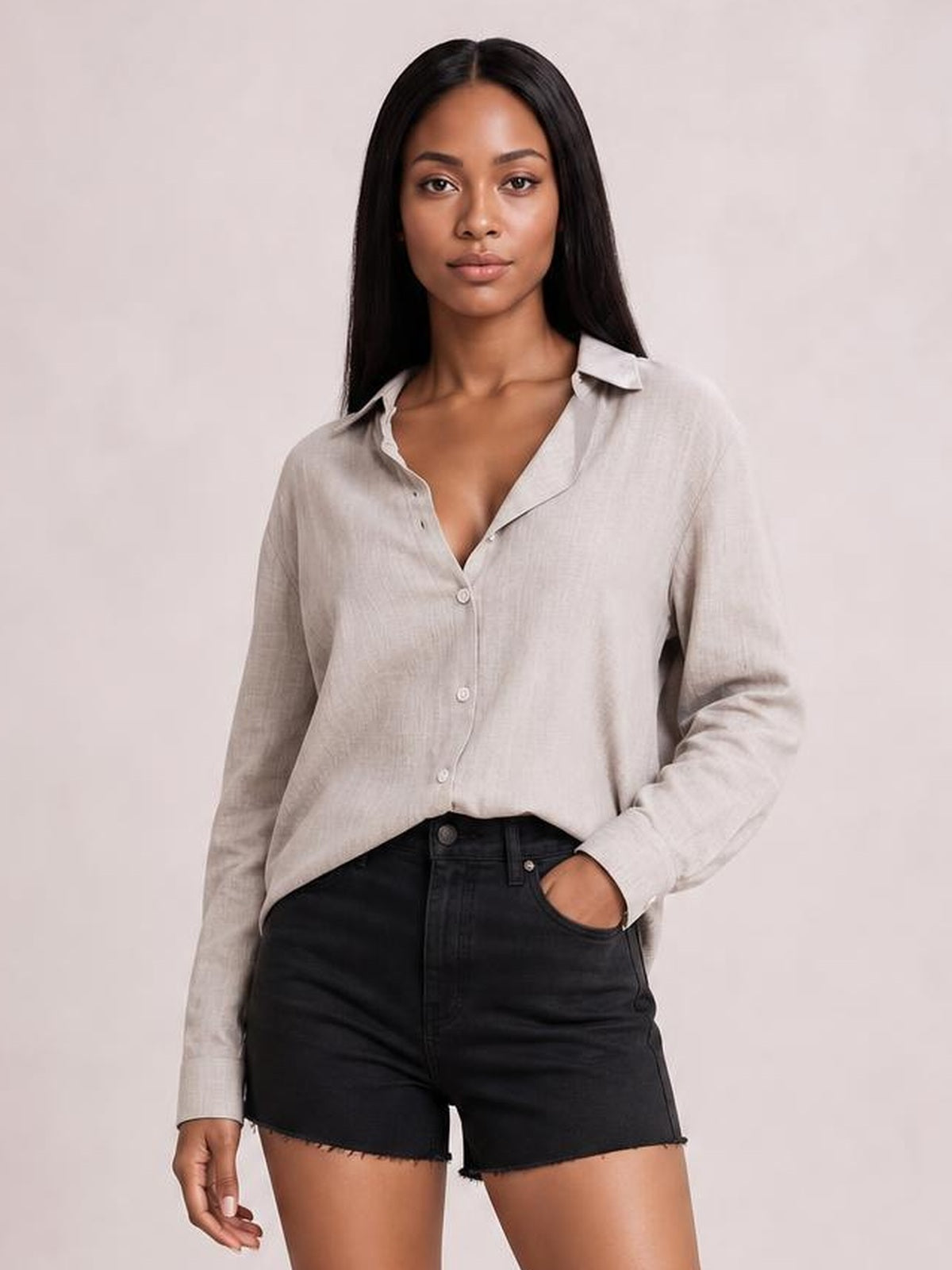 Model wearing a light beige textured button-front shirt with a collared neckline, long sleeves, relaxed regular silhouette, and curved hem.