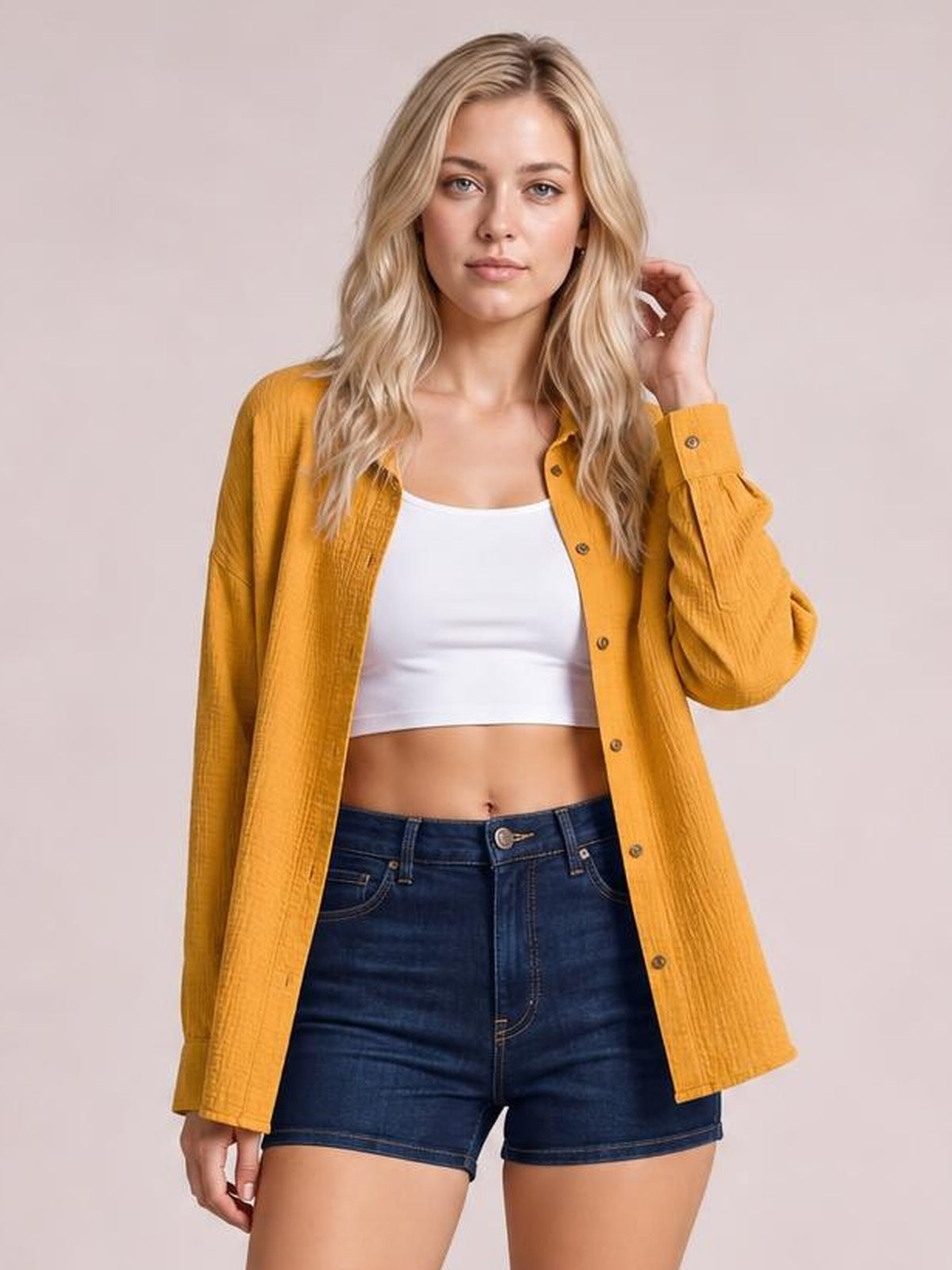 Model wearing a mustard-yellow textured dropped-shoulder longline shirt with a collared neckline, button front, long sleeves, and pockets.