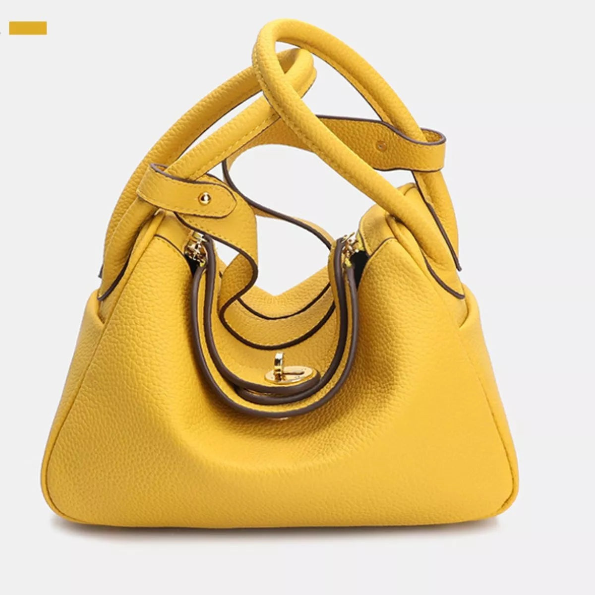 Small yellow textured PU leather handbag with a structured trapezoid silhouette, twin rounded handles, dark contrast trim, and a gold-tone front clasp.