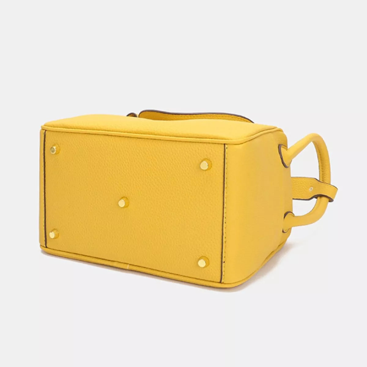 Small yellow textured PU leather handbag with a structured rectangular silhouette, stitched edges, top handle, side loops, and protective metal feet.