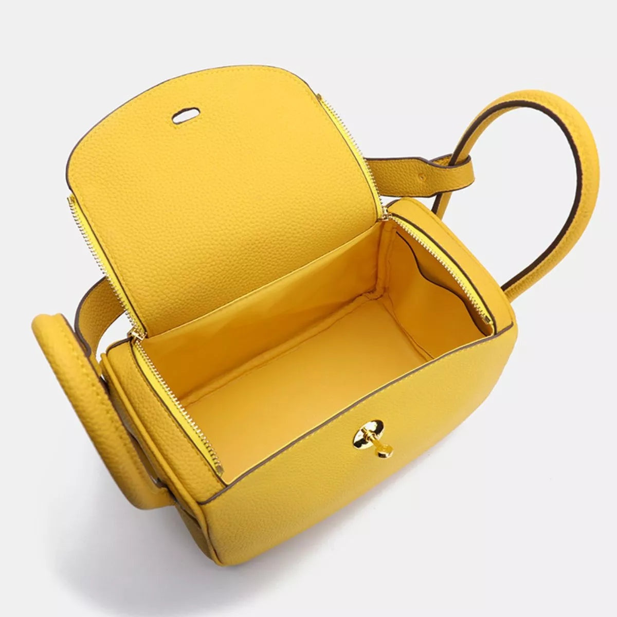 Small yellow textured PU leather handbag shown open, with a structured rectangular silhouette, zip-around opening, roomy interior, and rounded top handles.