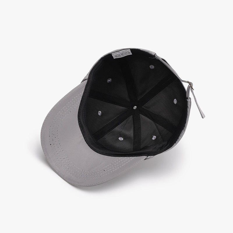 Gray cotton baseball cap shown from underneath with a curved brim, paneled crown, neat topstitching, and an adjustable buckle back strap.