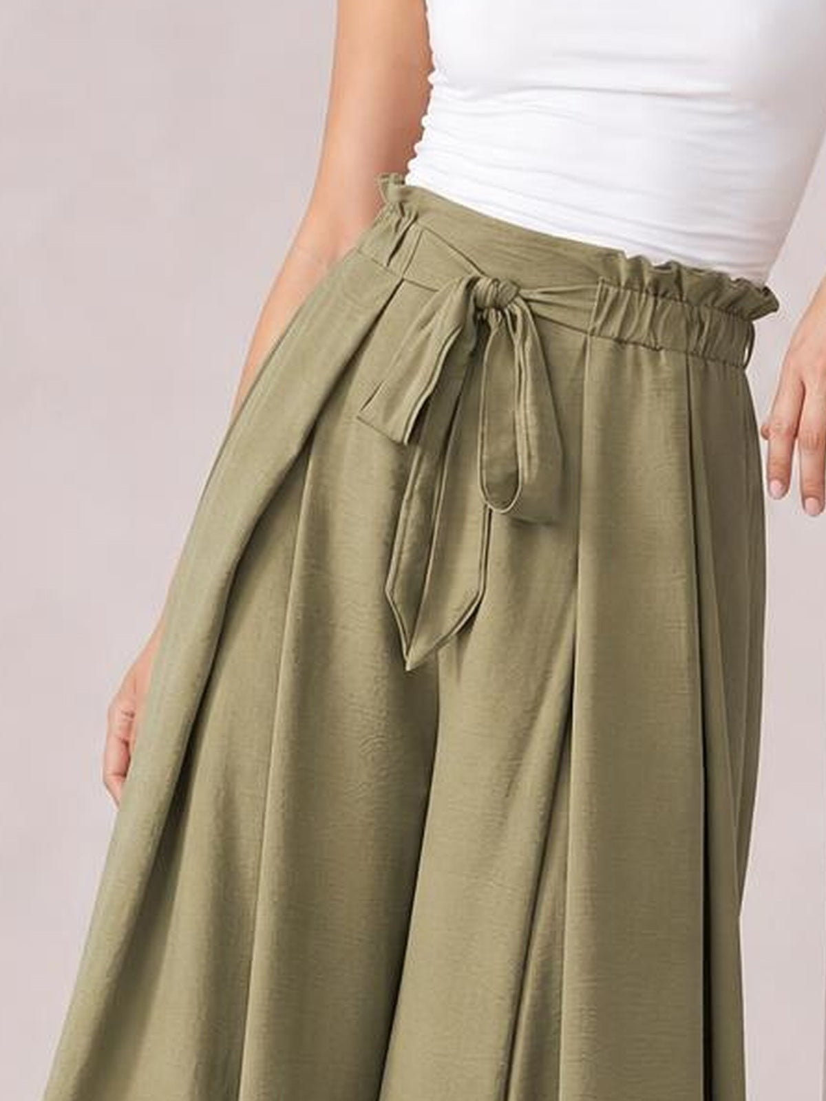 A model wears olive Tied Slit Wide Leg Pants with a gathered waistband, front tie belt, relaxed wide-leg silhouette, and hands resting at the sides.